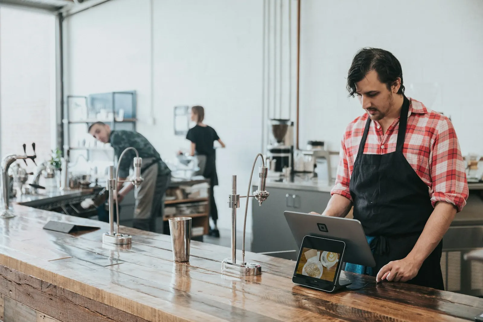 Restaurant operator using a tablet at the counter