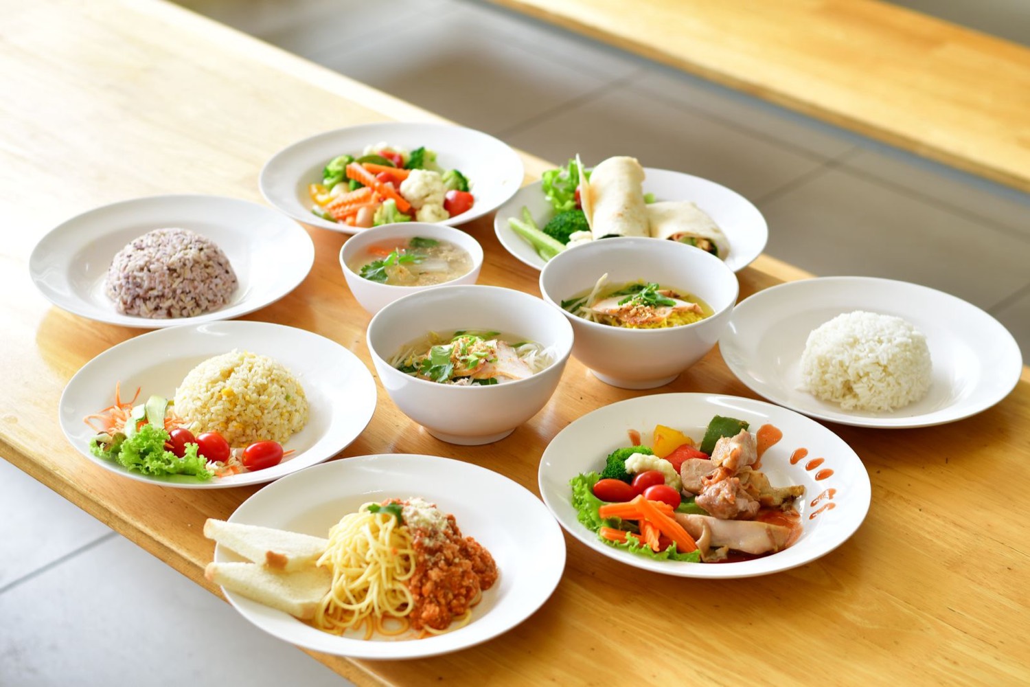 Table of plated rice, noodle and vegetable dishes